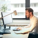 Man Happy While Working on his Computer