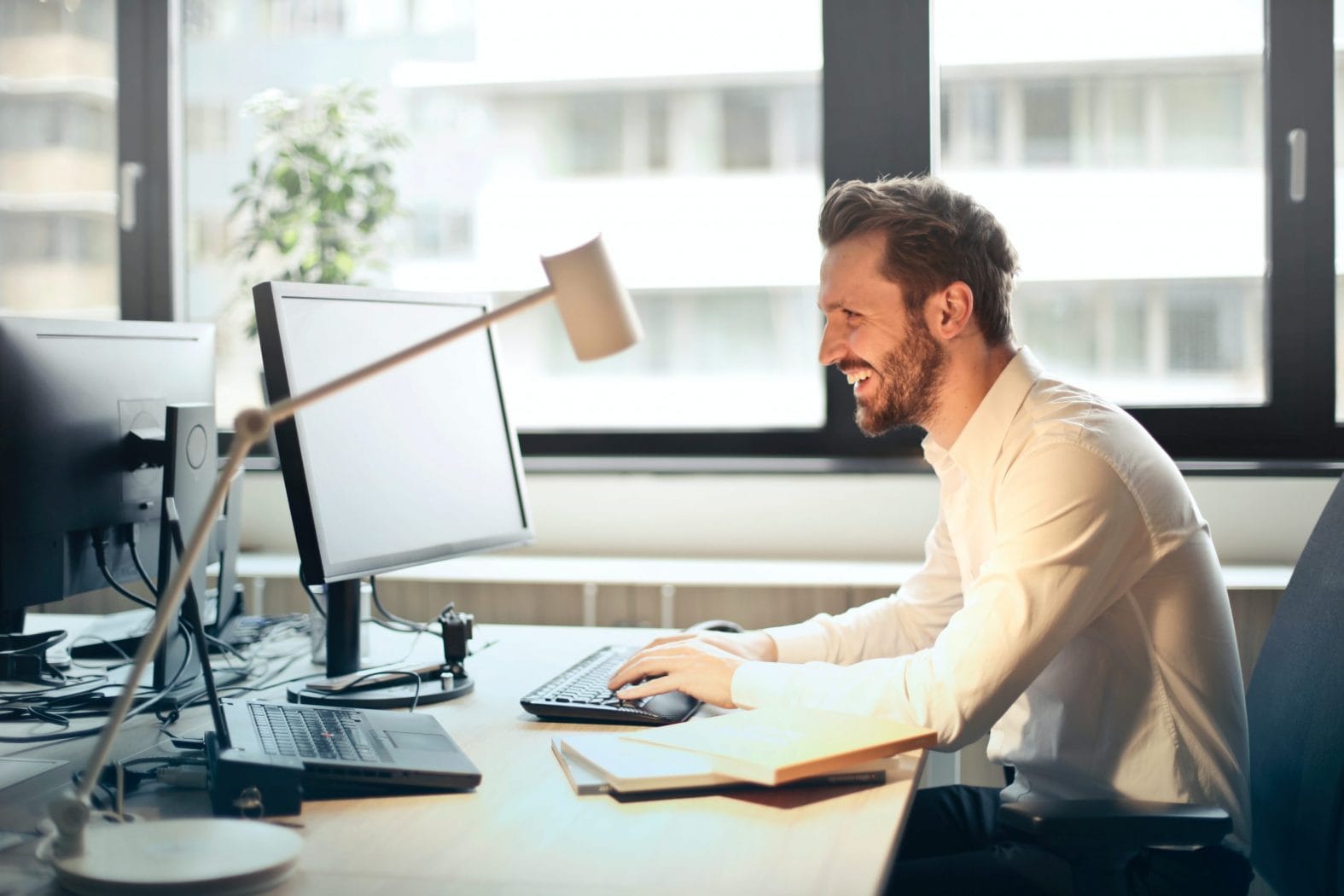 Man Happy While Working on his Computer